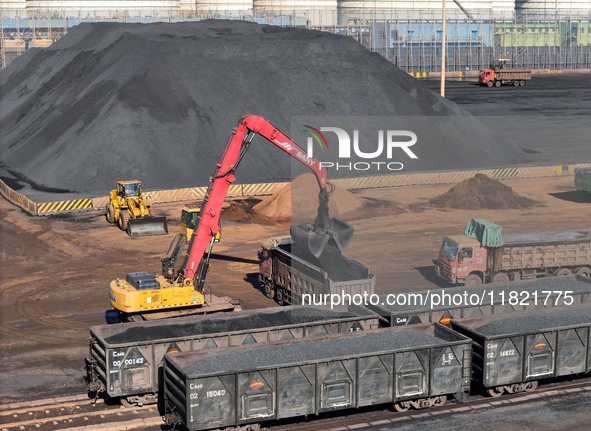 Loading machinery operates at the coal yard in Longkou Port Area, Yantai City, Shandong Province, China, on November 29, 2024. 