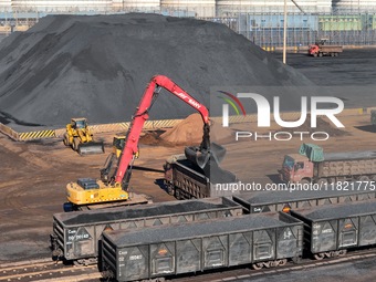 Loading machinery operates at the coal yard in Longkou Port Area, Yantai City, Shandong Province, China, on November 29, 2024. (