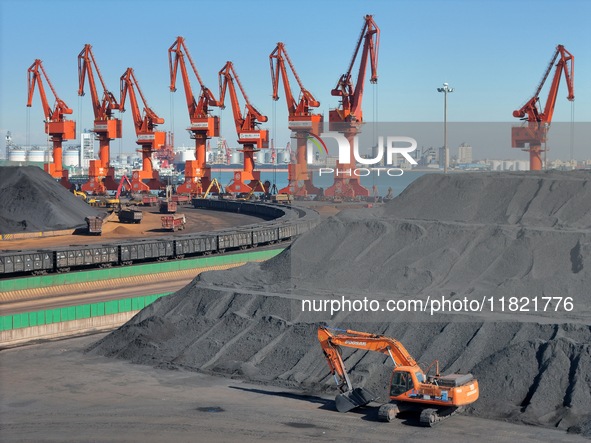 Loading machinery operates at the coal yard in Longkou Port Area, Yantai City, Shandong Province, China, on November 29, 2024. 