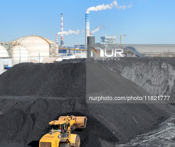 Loading machinery operates at the coal yard in Longkou Port Area, Yantai City, Shandong Province, China, on November 29, 2024. 