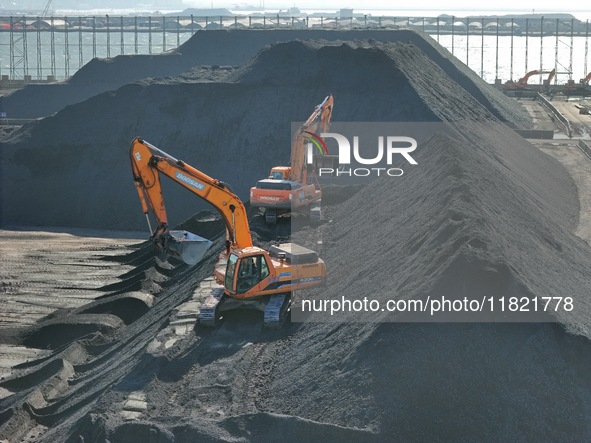 Loading machinery operates at the coal yard in Longkou Port Area, Yantai City, Shandong Province, China, on November 29, 2024. 