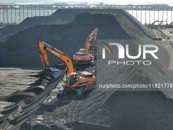 Loading machinery operates at the coal yard in Longkou Port Area, Yantai City, Shandong Province, China, on November 29, 2024. (