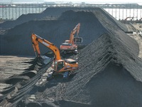 Loading machinery operates at the coal yard in Longkou Port Area, Yantai City, Shandong Province, China, on November 29, 2024. (