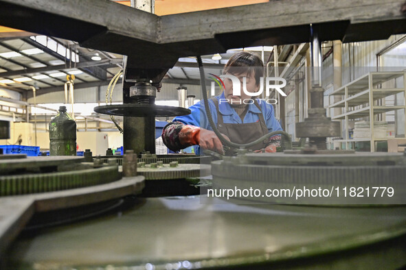 A worker works at an auto parts manufacturing enterprise in the Economic Development Zone of Qingzhou City, East China's Shandong Province,...