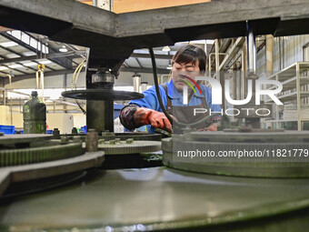 A worker works at an auto parts manufacturing enterprise in the Economic Development Zone of Qingzhou City, East China's Shandong Province,...