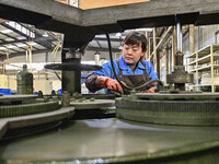 A worker works at an auto parts manufacturing enterprise in the Economic Development Zone of Qingzhou City, East China's Shandong Province,...