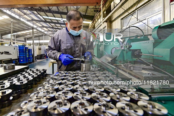 A worker works at an auto parts manufacturing enterprise in the Economic Development Zone of Qingzhou City, East China's Shandong Province,...