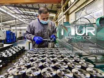 A worker works at an auto parts manufacturing enterprise in the Economic Development Zone of Qingzhou City, East China's Shandong Province,...