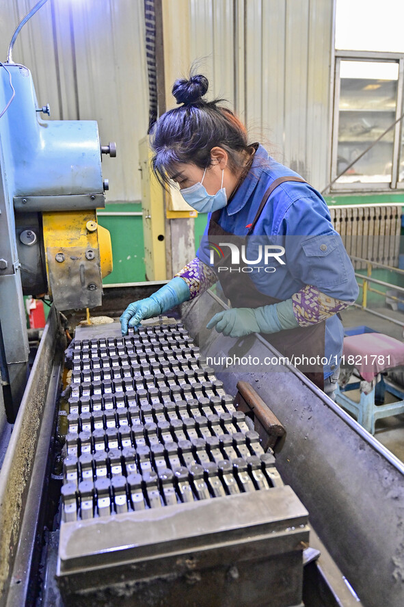 A worker works at an auto parts manufacturing enterprise in the Economic Development Zone of Qingzhou City, East China's Shandong Province,...