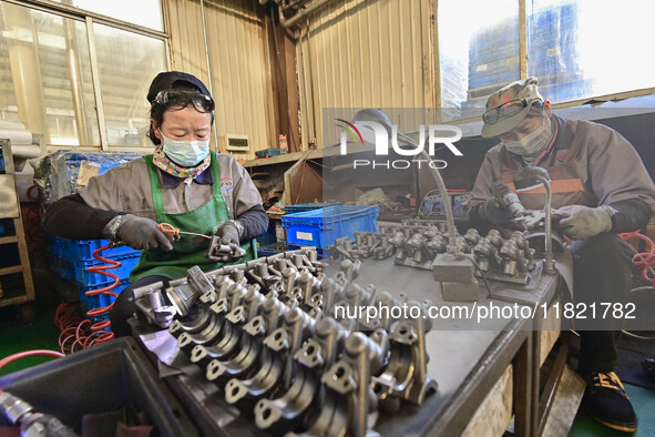 A worker works at an auto parts manufacturing enterprise in the Economic Development Zone of Qingzhou City, East China's Shandong Province,...