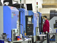 A worker works at an auto parts manufacturing enterprise in the Economic Development Zone of Qingzhou City, East China's Shandong Province,...