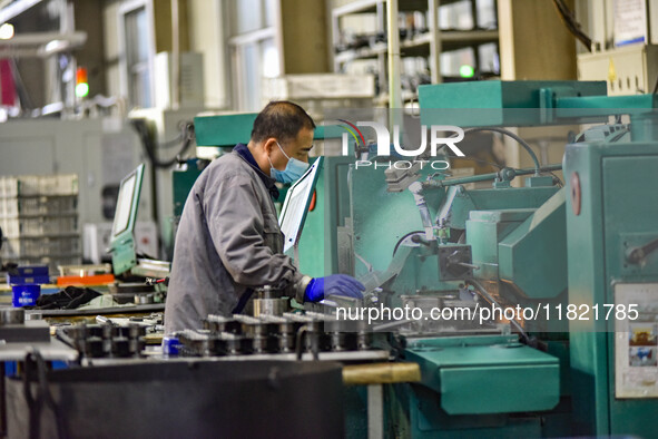 A worker works at an auto parts manufacturing enterprise in the Economic Development Zone of Qingzhou City, East China's Shandong Province,...