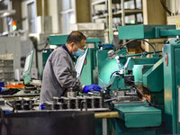 A worker works at an auto parts manufacturing enterprise in the Economic Development Zone of Qingzhou City, East China's Shandong Province,...