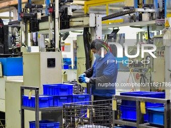 A worker works at an auto parts manufacturing enterprise in the Economic Development Zone of Qingzhou City, East China's Shandong Province,...