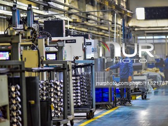 A worker works at an auto parts manufacturing enterprise in the Economic Development Zone of Qingzhou City, East China's Shandong Province,...