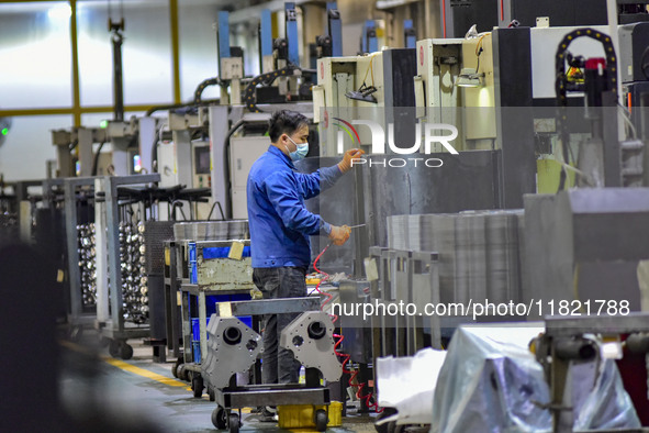 A worker works at an auto parts manufacturing enterprise in the Economic Development Zone of Qingzhou City, East China's Shandong Province,...