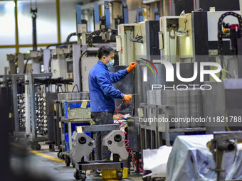 A worker works at an auto parts manufacturing enterprise in the Economic Development Zone of Qingzhou City, East China's Shandong Province,...