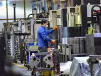 A worker works at an auto parts manufacturing enterprise in the Economic Development Zone of Qingzhou City, East China's Shandong Province,...