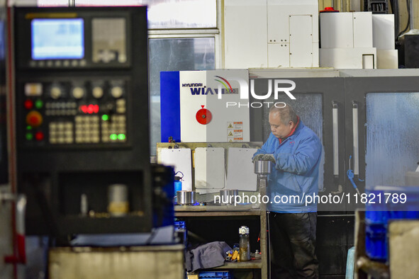 A worker works at an auto parts manufacturing enterprise in the Economic Development Zone of Qingzhou City, East China's Shandong Province,...