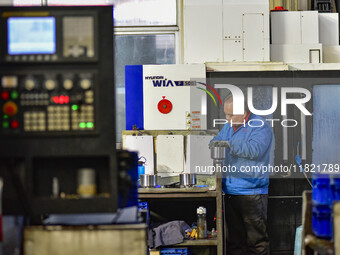 A worker works at an auto parts manufacturing enterprise in the Economic Development Zone of Qingzhou City, East China's Shandong Province,...