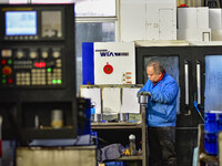 A worker works at an auto parts manufacturing enterprise in the Economic Development Zone of Qingzhou City, East China's Shandong Province,...