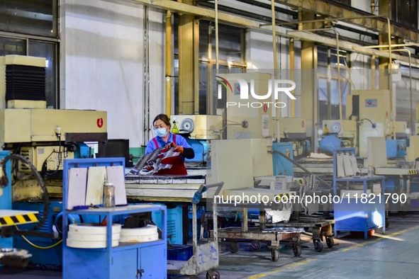 A worker works at an auto parts manufacturing enterprise in the Economic Development Zone of Qingzhou City, East China's Shandong Province,...