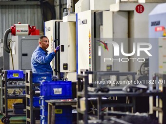 A worker works at an auto parts manufacturing enterprise in the Economic Development Zone of Qingzhou City, East China's Shandong Province,...