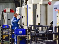 A worker works at an auto parts manufacturing enterprise in the Economic Development Zone of Qingzhou City, East China's Shandong Province,...