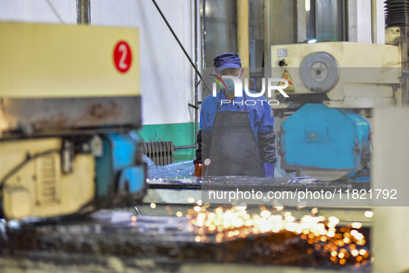 A worker works at an auto parts manufacturing enterprise in the Economic Development Zone of Qingzhou City, East China's Shandong Province,...