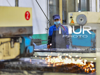 A worker works at an auto parts manufacturing enterprise in the Economic Development Zone of Qingzhou City, East China's Shandong Province,...