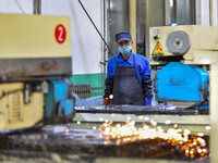 A worker works at an auto parts manufacturing enterprise in the Economic Development Zone of Qingzhou City, East China's Shandong Province,...