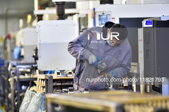 A worker works at an auto parts manufacturing enterprise in the Economic Development Zone of Qingzhou City, East China's Shandong Province,...