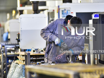 A worker works at an auto parts manufacturing enterprise in the Economic Development Zone of Qingzhou City, East China's Shandong Province,...