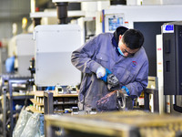 A worker works at an auto parts manufacturing enterprise in the Economic Development Zone of Qingzhou City, East China's Shandong Province,...