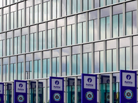 In Antwerp, Belgium, on August 1, 2023, the glass facade of a police station prominently displays signs of the Belgian police with their rec...