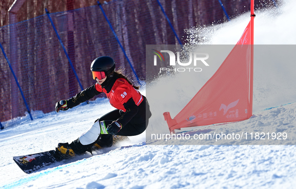 Dong Yuyue of China competes during the first round of the women's snowboard parallel giant slalom at the 2024-2025 ISF Snowboard Parallel E...