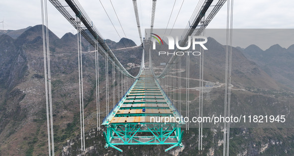 The Huajiang Canyon Bridge is under construction in Qianxinan, Guizhou province, China, on November 30, 2024. The bridge is a steel girder s...