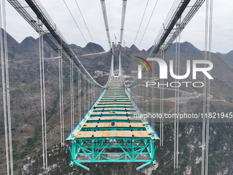 The Huajiang Canyon Bridge is under construction in Qianxinan, Guizhou province, China, on November 30, 2024. The bridge is a steel girder s...