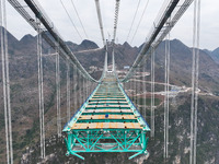 The Huajiang Canyon Bridge is under construction in Qianxinan, Guizhou province, China, on November 30, 2024. The bridge is a steel girder s...