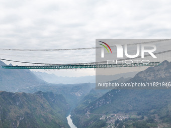 The Huajiang Canyon Bridge is under construction in Qianxinan, Guizhou province, China, on November 30, 2024. The bridge is a steel girder s...