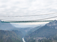 The Huajiang Canyon Bridge is under construction in Qianxinan, Guizhou province, China, on November 30, 2024. The bridge is a steel girder s...