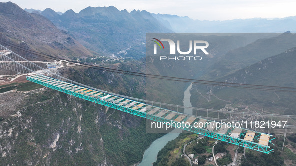 The Huajiang Canyon Bridge is under construction in Qianxinan, Guizhou province, China, on November 30, 2024. The bridge is a steel girder s...