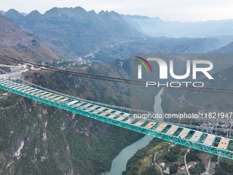 The Huajiang Canyon Bridge is under construction in Qianxinan, Guizhou province, China, on November 30, 2024. The bridge is a steel girder s...