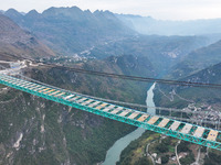 The Huajiang Canyon Bridge is under construction in Qianxinan, Guizhou province, China, on November 30, 2024. The bridge is a steel girder s...