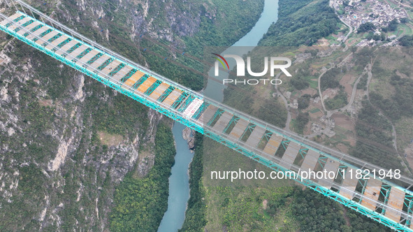 The Huajiang Canyon Bridge is under construction in Qianxinan, Guizhou province, China, on November 30, 2024. The bridge is a steel girder s...