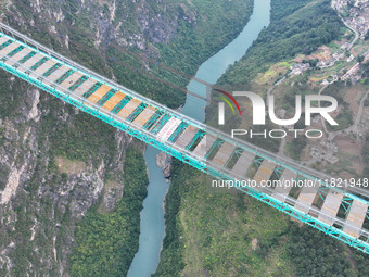 The Huajiang Canyon Bridge is under construction in Qianxinan, Guizhou province, China, on November 30, 2024. The bridge is a steel girder s...