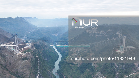 The Huajiang Canyon Bridge is under construction in Qianxinan, Guizhou province, China, on November 30, 2024. The bridge is a steel girder s...