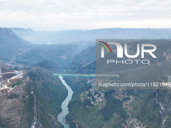 The Huajiang Canyon Bridge is under construction in Qianxinan, Guizhou province, China, on November 30, 2024. The bridge is a steel girder s...