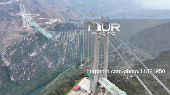 The Huajiang Canyon Bridge is under construction in Qianxinan, Guizhou province, China, on November 30, 2024. The bridge is a steel girder s...