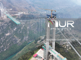 The Huajiang Canyon Bridge is under construction in Qianxinan, Guizhou province, China, on November 30, 2024. The bridge is a steel girder s...